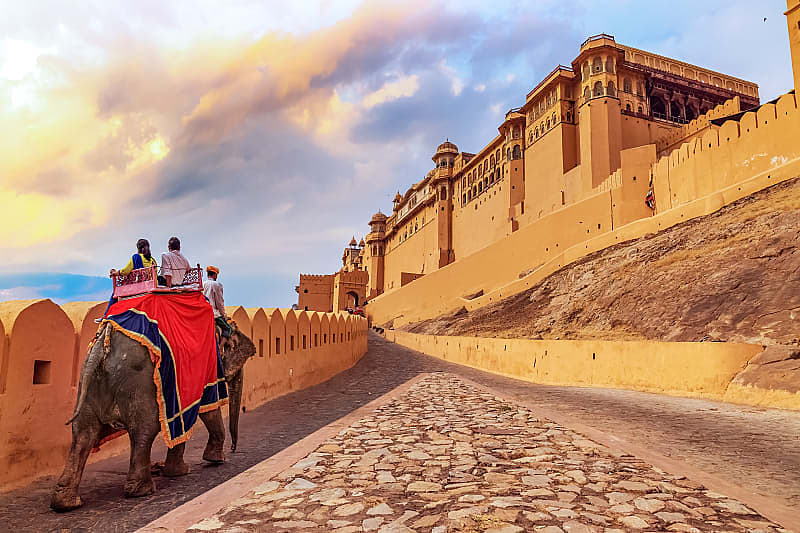Nepal and India for Seniors Itinerary Senior tourists enjoy elephant ride at Amer Fort in Jaipur, India