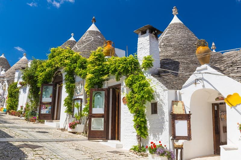 Luxuries of Puglia to Amalfi Coast Tour White circular Trulli houses of Alberobello in the Puglia region of Italy