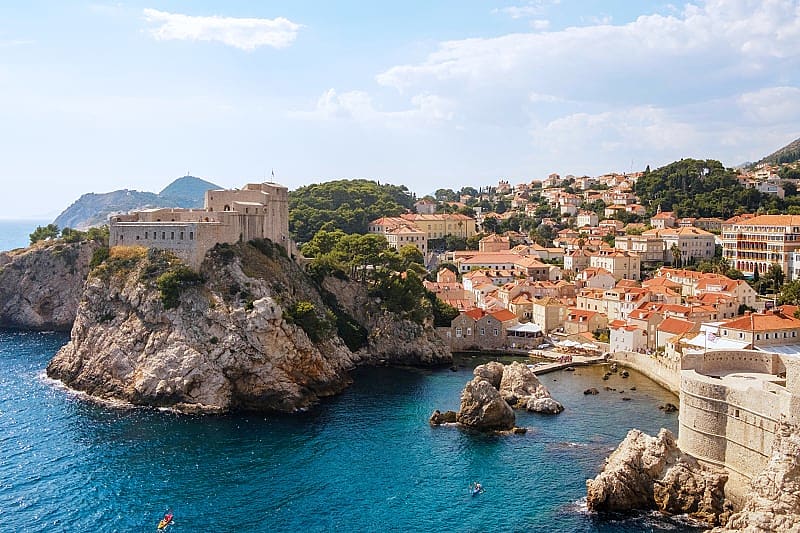 Dubrovnik is an ancient city on a steep promontory above the sea, surrounded by fortress walls