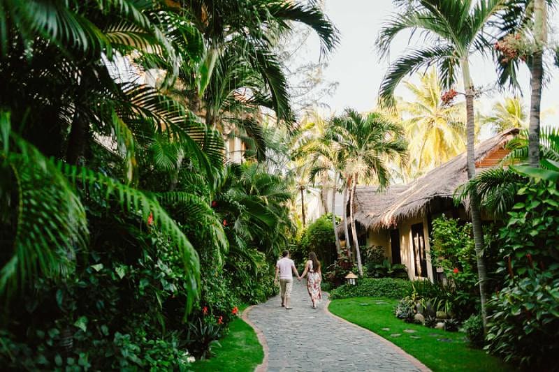 A couple walking through a beach resort in Vietnam.