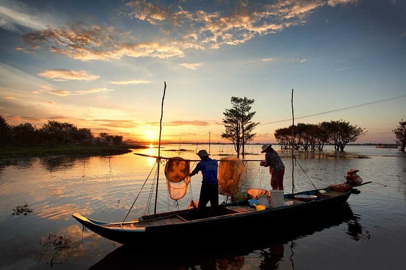 Family fishing in the flooding season on Mekong Delta river, Chau Doc