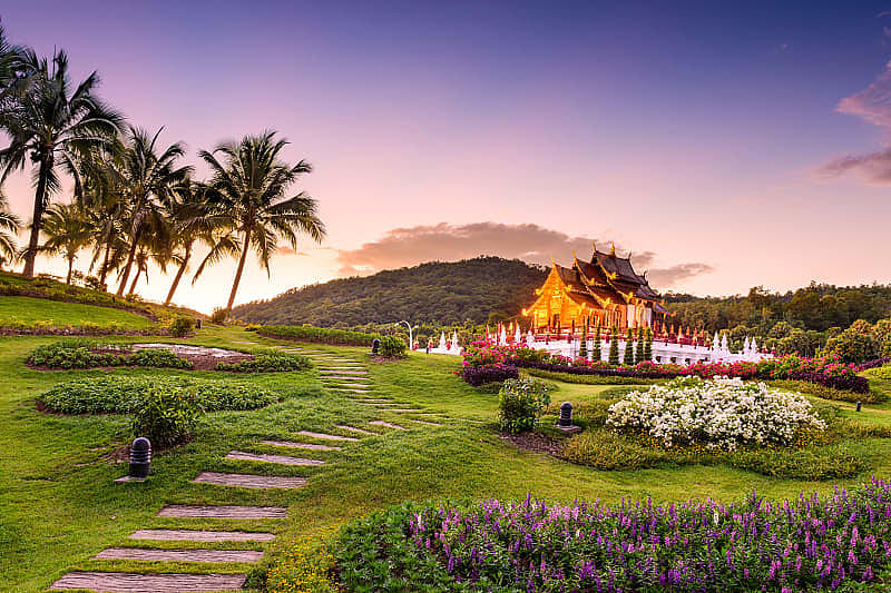 Pathway through gardens leading to Kor Khum Luang Temple at Royal Park Rajapruek in Chiang Mai, Thailand