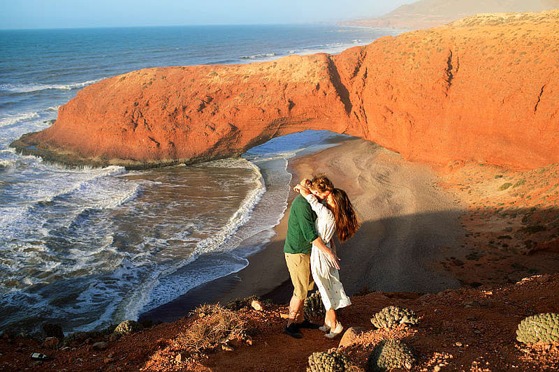 Romantic Morocco Tour: Beauty, Indulgence & Luxury Couple at Legzira Beach near Agadir, Morocco