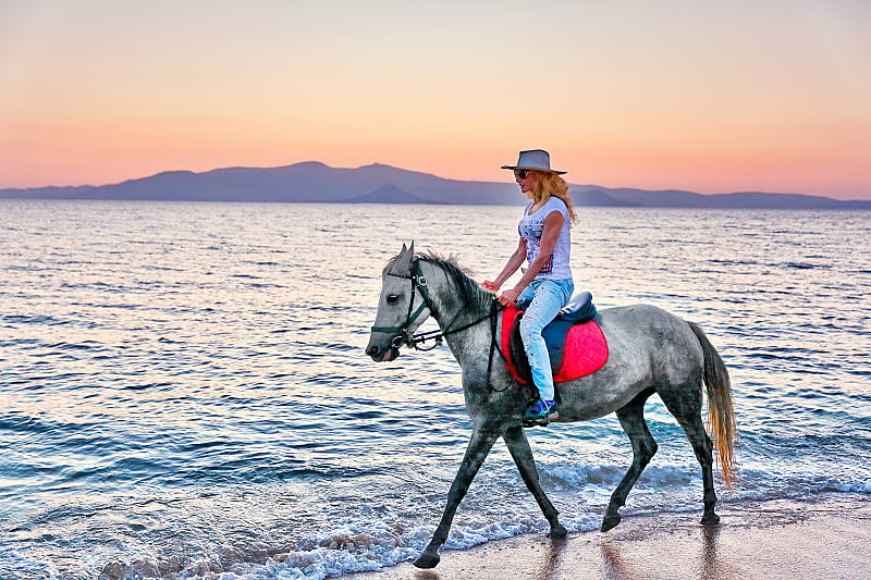 Horseback riding on the beach in Greece.