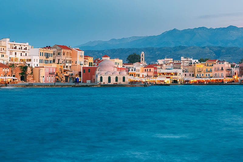 Chania in Crete, Greece Venetian Quay of Chania with Kucuk Hasan Pasha Mosque during twilight blue hour, Crete, Greece