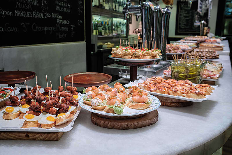 Spanish tapas, or pintxos, on the counter at a bar in San Sebastian, Spain