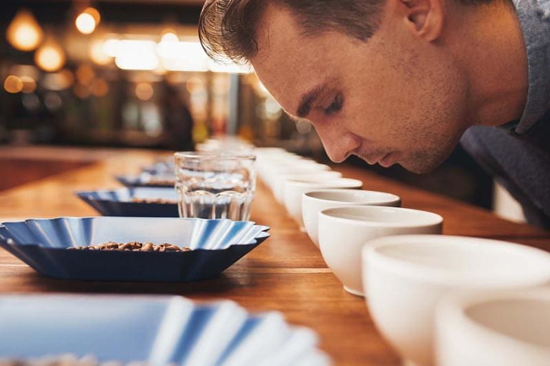 Costa Rica man smelling aromatic coffee at a tasting