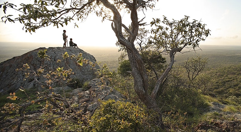 Phinda Private Reserve, South Africa. Photo courtesy andBeyond Couple viewing the vast landscape of Phinda Private Game Reserve at sunset in South Africa