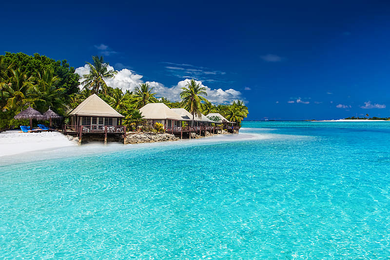 Relax on the luxurious white sand beach that surrounds your remote island accommodation.
