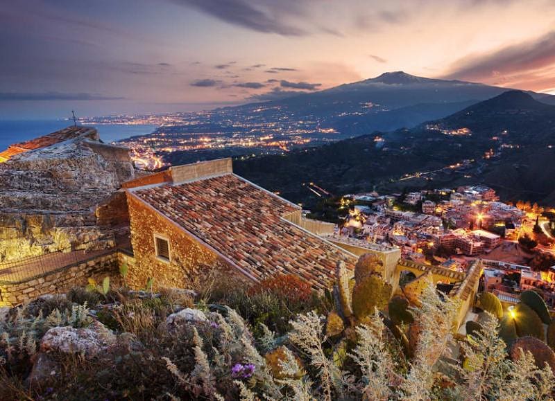 View of the hilltop town Taormina, Italy at dusk