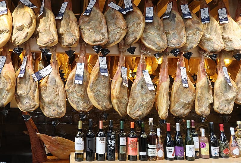 Jamon and wine for sale at a market in Spain.