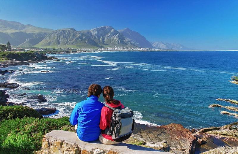 Happy couple looks at the beautiful view of the Old Harbor, Hermanus