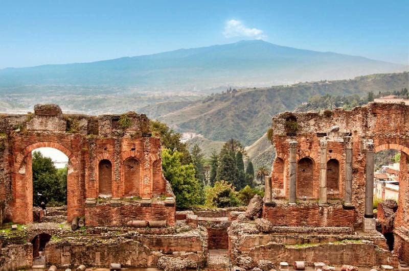 Visit the Roman ruins in Taormina overlooking Mount Etna