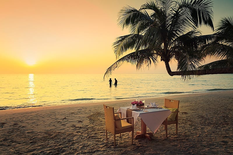 Honeymoon couple enjoying a romantic dinner on the beach in Costa Rica