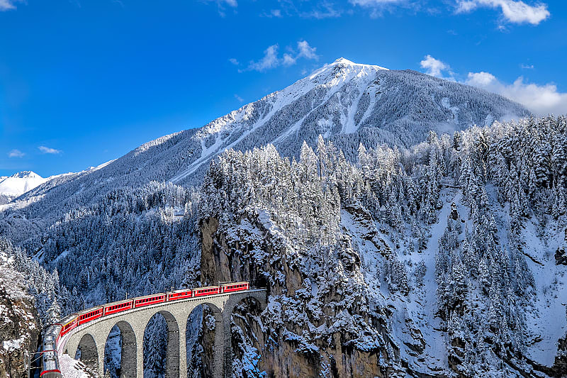 Glacier Express train traveling through the alps in Switzerland