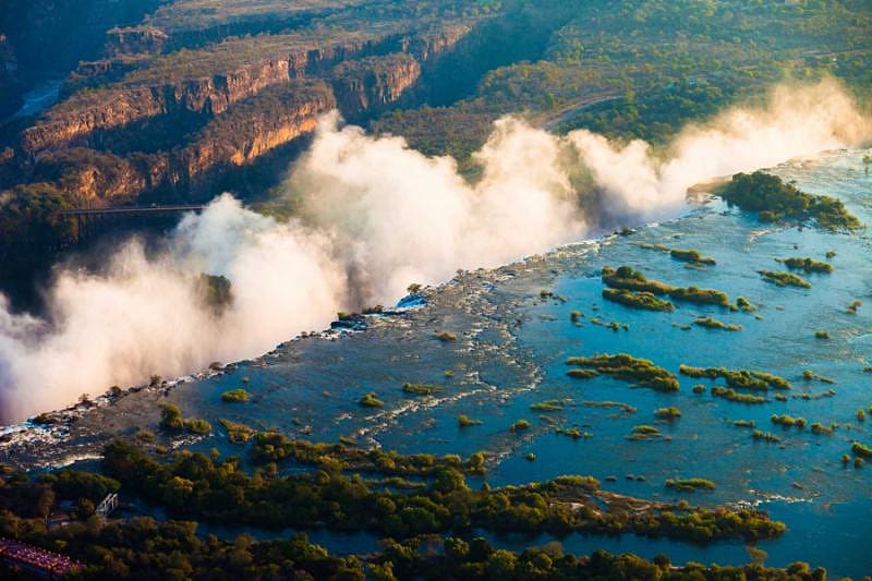 The edge of Victoria Falls with the waterfall's mist rising into view | Zambia, Africa