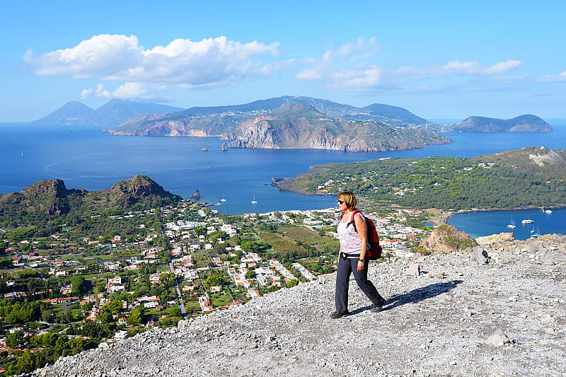 Woman hiking on the Gran Crater on Vulcano, on of seven Aeolian Island in Sicily, Italy