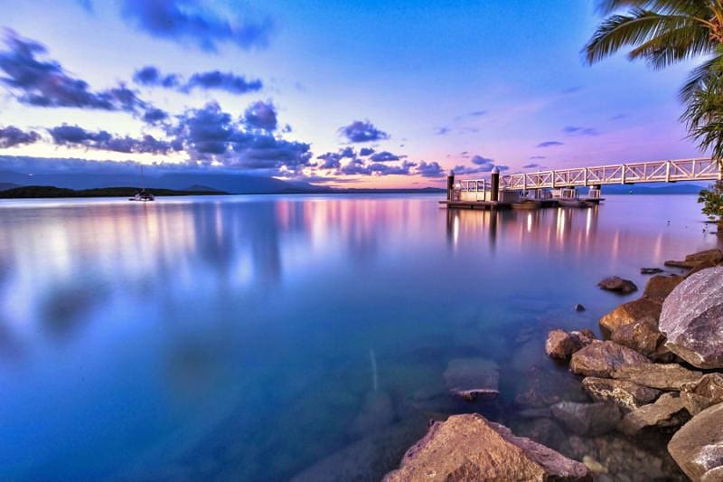 Nightime view of Port Douglas looking out onto the water and pier.