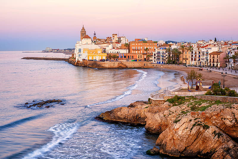 Sand beach and historical Old Town in mediterranean resort Sitges, Spain