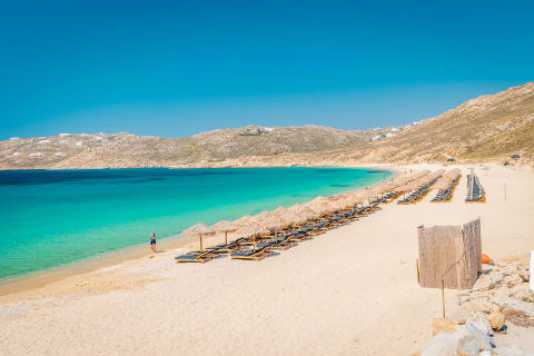 Lone traveler at Ella Beach on Mykonos island Greece