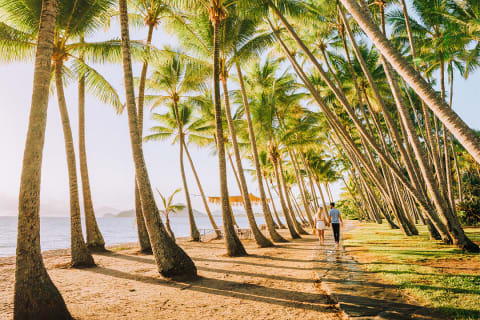 Coulple taking a romantic walk in Palm Cove in Queensland, Australia