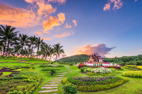 Pathway through gardens leading to Kor Khum Luang Temple at Royal Park Rajapruek in Chiang Mai, Thailand