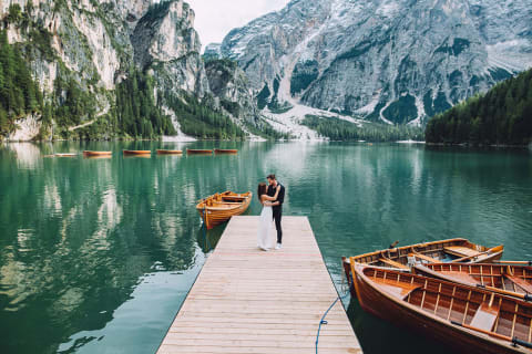 Honeymoon couple at mountain lake in Prags Dolomites , South Tyrol, Italy