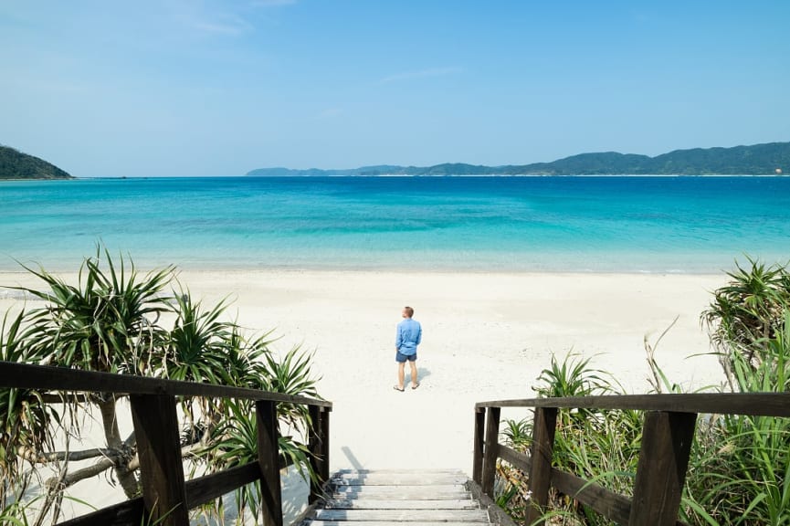 A man admires a beach in Okinawa