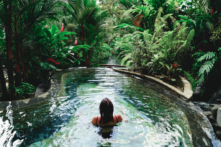 Woman relaxing in thermal hot springs in Costa Rica