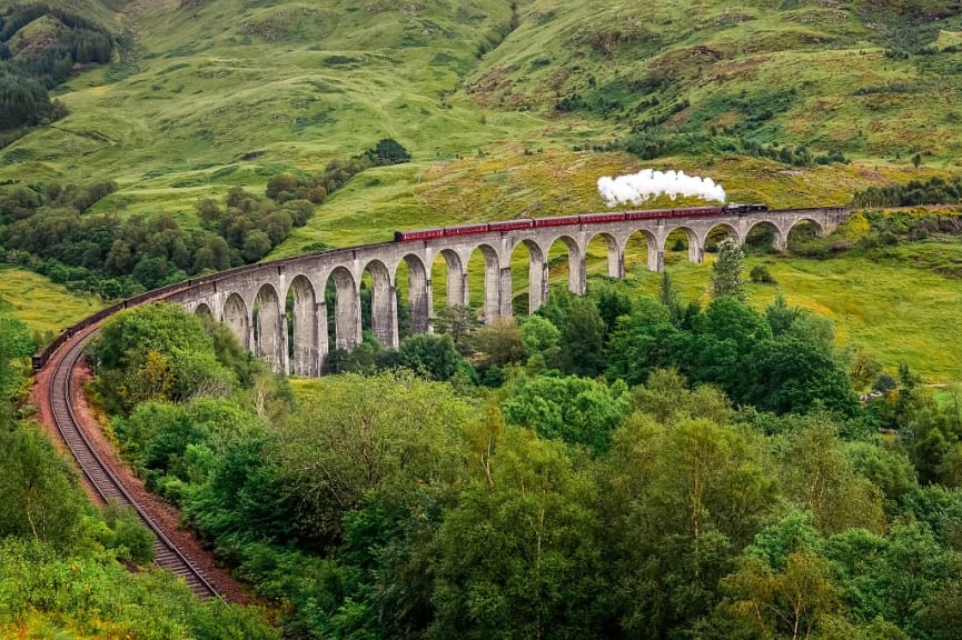 Jacobite steam train going across the Glenfinnan Viaduct in Scotland, UK