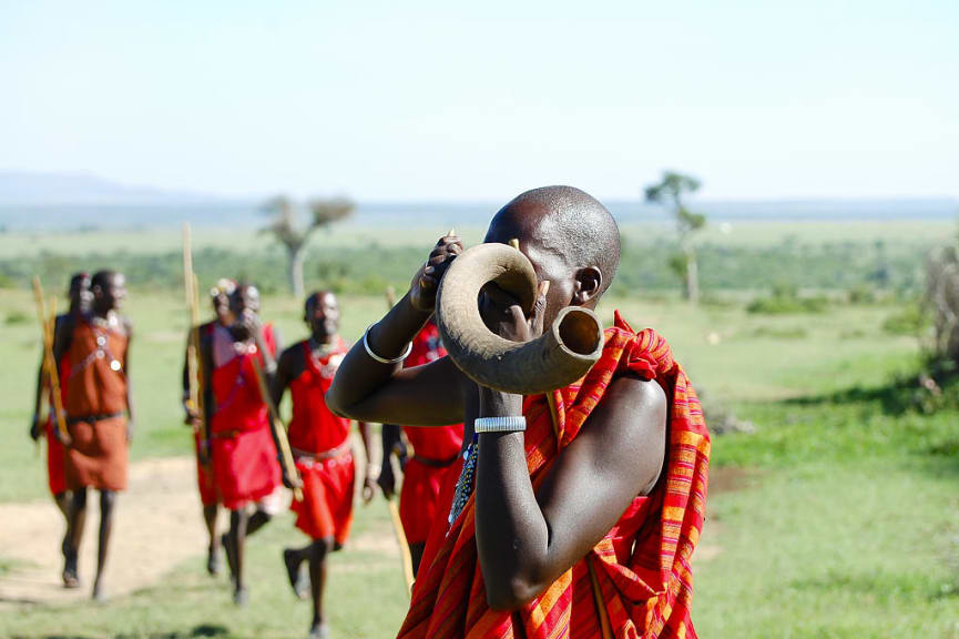 Maasai warrior blowing a kudu horn