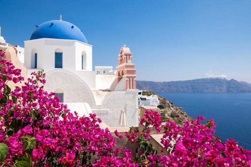 Traditional cycladic houses with flowers in Oia village, Santorini, Greece