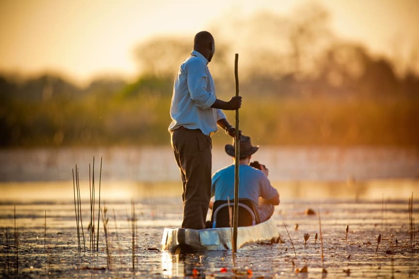 Mokoro boat meandering down the river in the Okavango Delta, Botswana