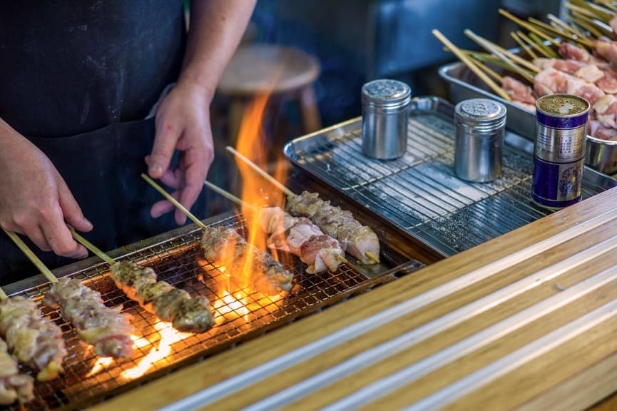 Person grilling yakitori in Tokyo, Japan