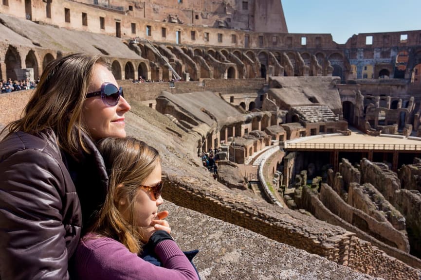 Mother and daughter dressed in warm clothes at the Colosseum in Rome, Italy