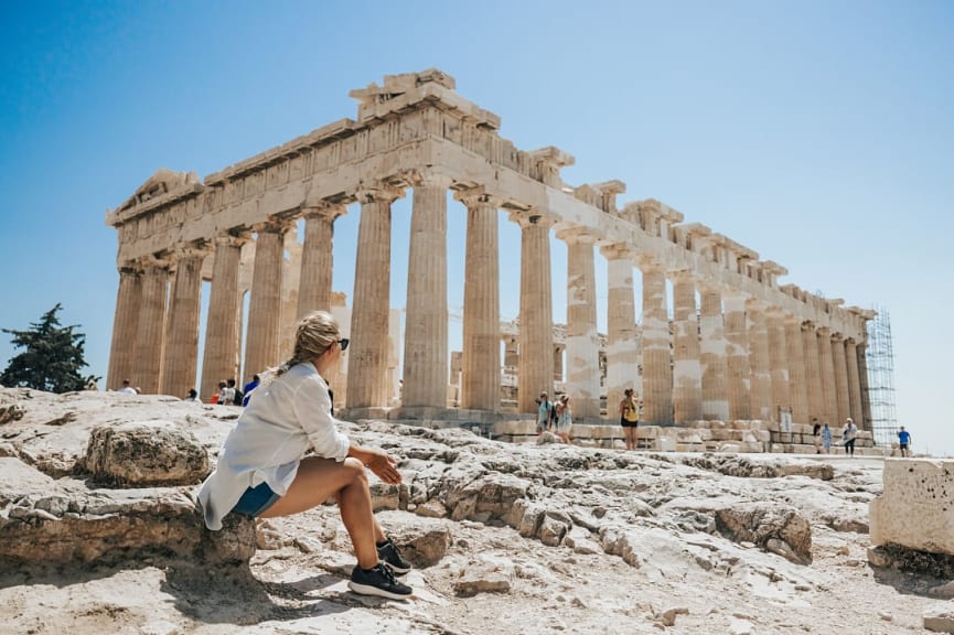 Woman relaxing while looking at the Parthenon in Athens, Greece