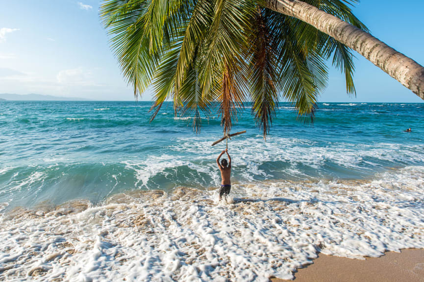 Young boy playing at Punta Uva beach, Costa Rica