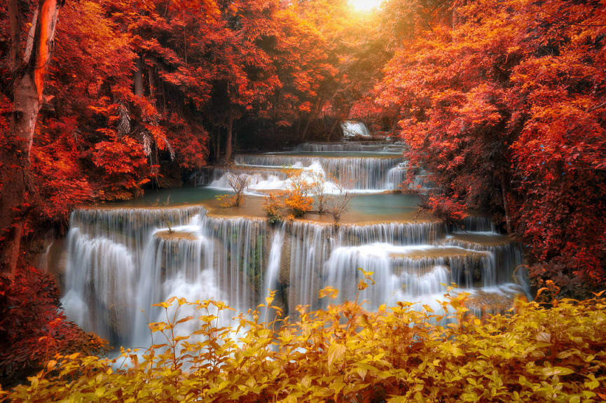 Autumn foliage surrounding Huai Mae Khamin Waterfall in Kanchanaburi, Thailand