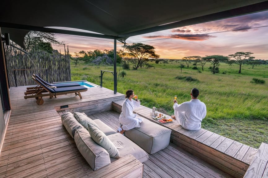 Couple watching the sunrise at Lemala Nanukie Lodge in the Serengeti, Tanzania