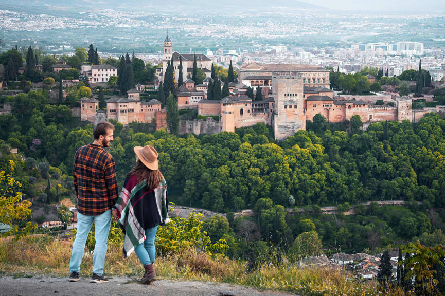 Couple at romantic overlook of Moorish Alhambra in Granada, Spain