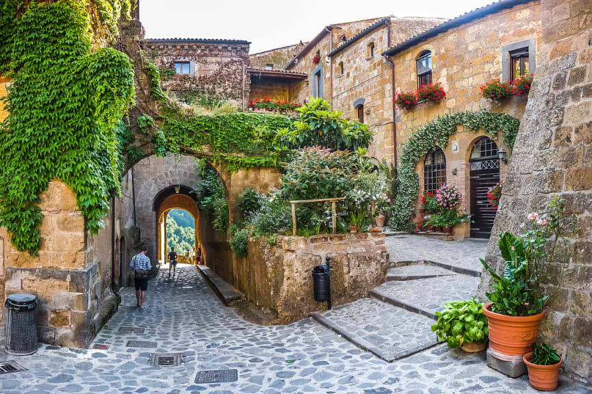 Walking tour through medieval alleyways in famous Civita di Bagnoregio in Lazio, Italy