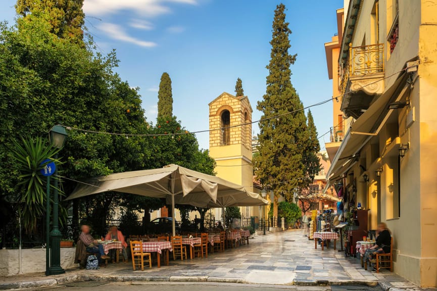 Old cozy street in Plaka district with cafes and restaurants in Athens, Greece