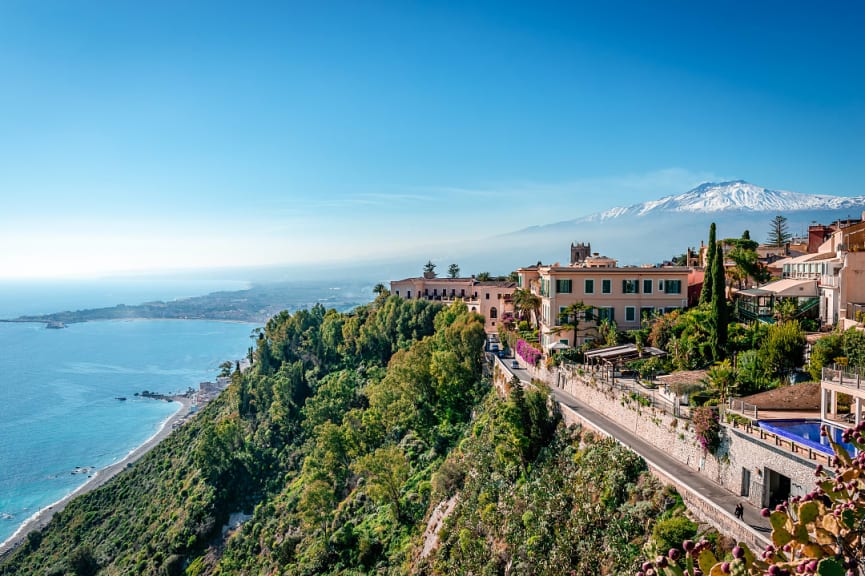 View of Taormina, Mt Etna and the Ionian sea in Sicily, Italy.