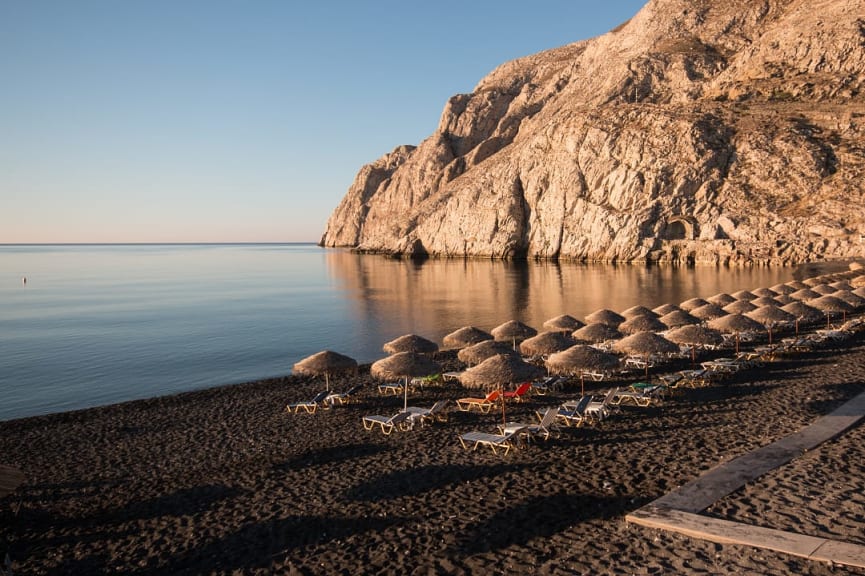 Black sand beach in Kamari in Santorini, Greece