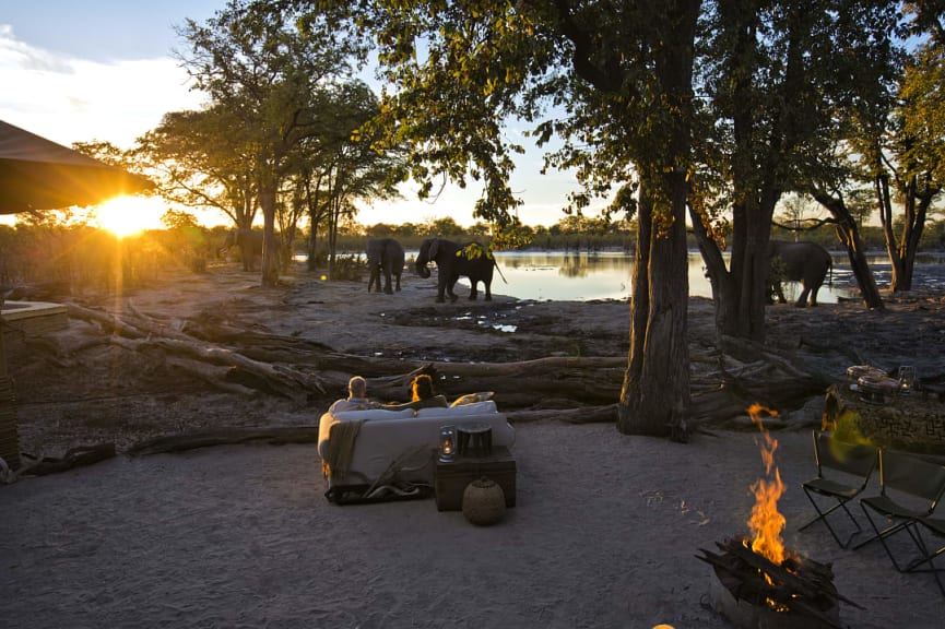 Senior couple watching elephants at a luxury lodge in Botswana 