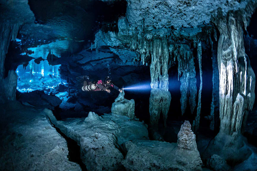 Scuba diver exploring Dos Ojos Cenote, Mexico