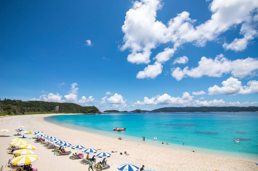 Umbrellas line the coastal beach on Zamami Island, Japan