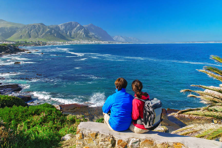 Couple looking out to the bay from  Gearing's Point in Hermanus, South Africa