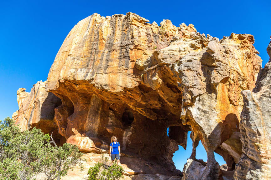 Woman exploring Stadsaal Caves in Cederberg Wilderness Area, South Africa