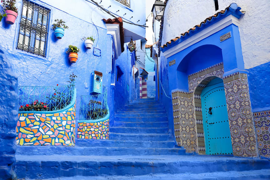 Blue walls and stairwell leading to a winding blue alley in Chefchaouen, Morocco